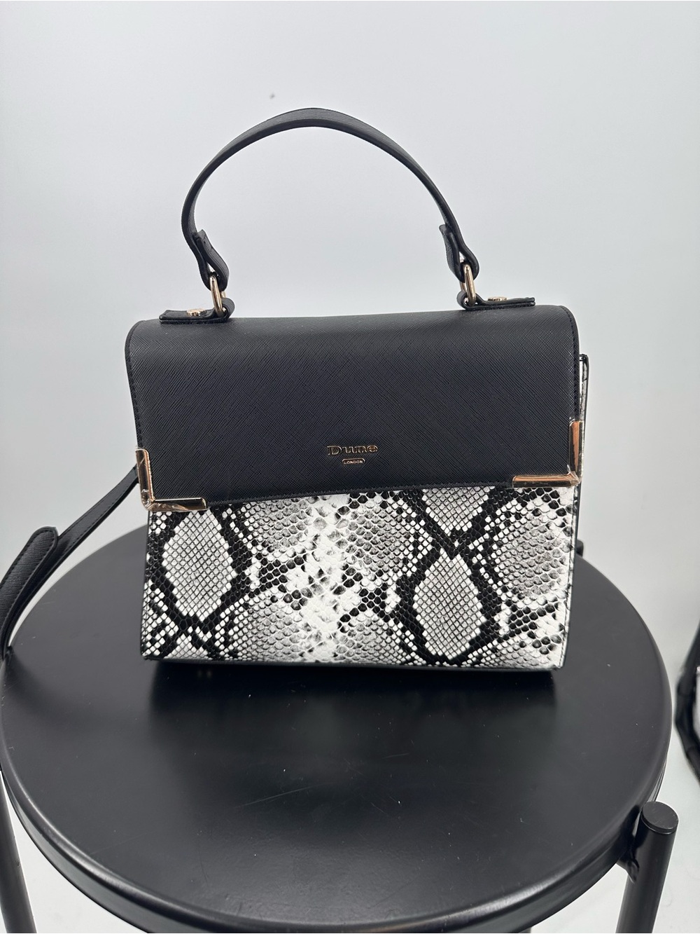 Top Handle Handbag from Dune London with Black, Gold, and Snakeskin Print